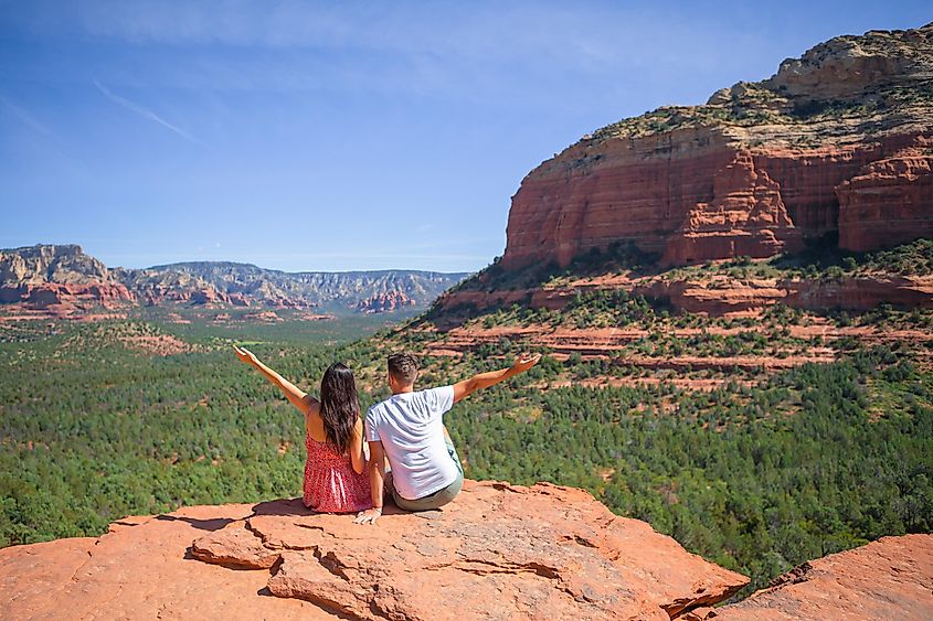 Panoramic landscape view of Devil's Bridge Trail in Sedona, Arizona, USA, with a happy couple enjoying the famous trail.