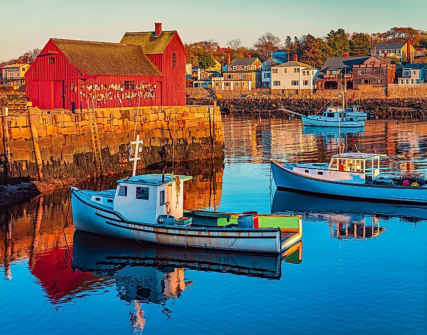 Rockport Harbor in Massachusetts with it's lobster boats and village reflect in the still water of the day.