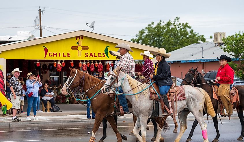 Local farm and ranch workers riding horses in the parade during the annual Hatch Chile Festival. Image credit kenelamb photographic via Shutterstock
