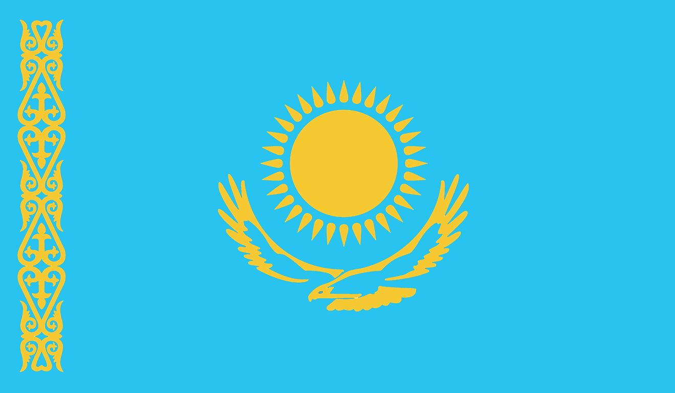 The national flag Kazakhstan consists of a blue field with gold sun with 32 rays above a soaring golden steppe eagle in the middle and a  national ornamental pattern "koshkar-muiz" (the horns of the ram) in gold on the hoist.
