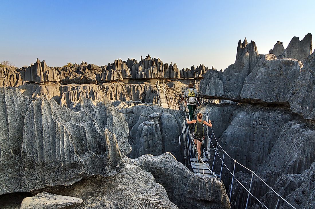 Tourists explore the beautiful limestone landscape of the Tsingy de Bemaraha Strict Nature Reserve, Madagascar. 