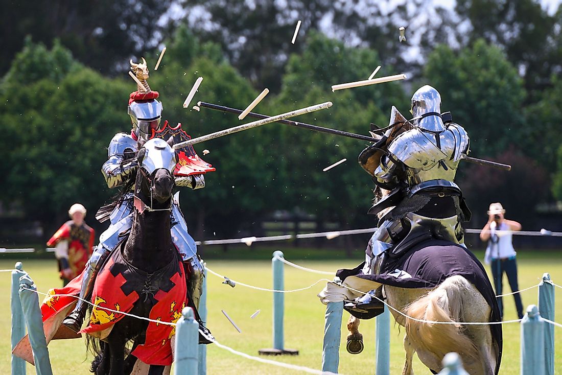 Men dressed up as knights compete in jousting. 