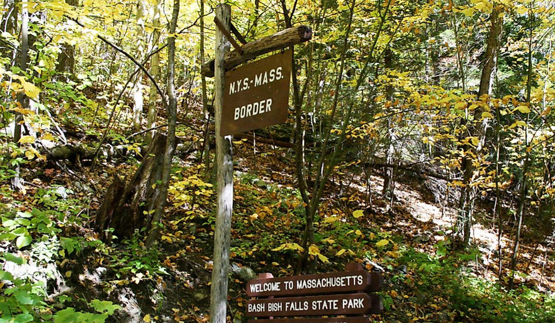 New York-Massachusetts border sign in Bish Bash Falls Lake Park.