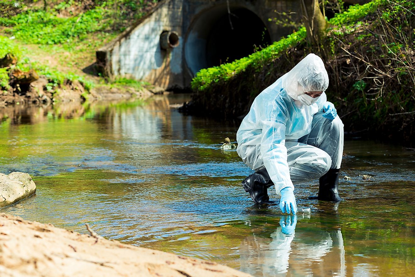 A researcher collecting sample of contaminated water for inspection of its quality in the lab. Image credit: kosmos111/Shutterstock.com