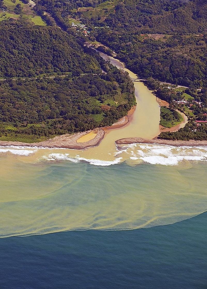 A Costa Rican river discharging massive amounts of its silt-laden waters (caused by erosion) into the ocean.