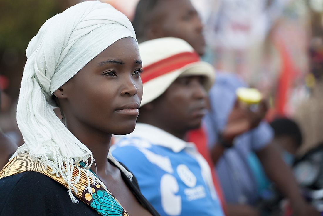 A young woman from Mozambique wearing a traditional scarf. Editorial credit: gaborbasch / Shutterstock.com.