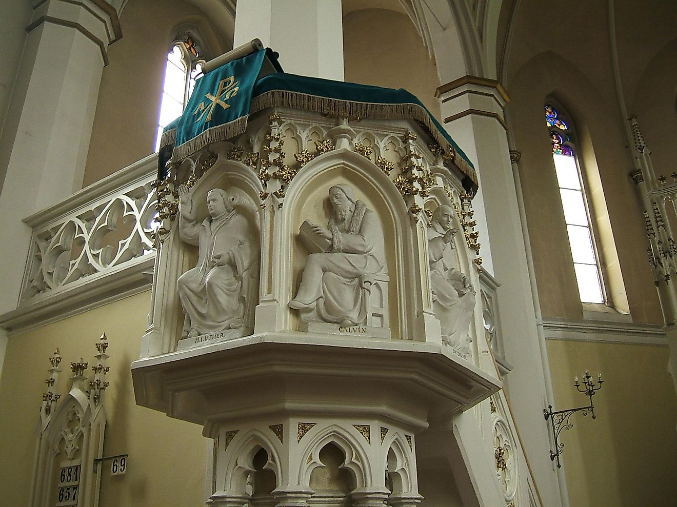 Martin Luther and John Calvin, key proponents of the Protestant Reformation are depicted on a church pulpit.