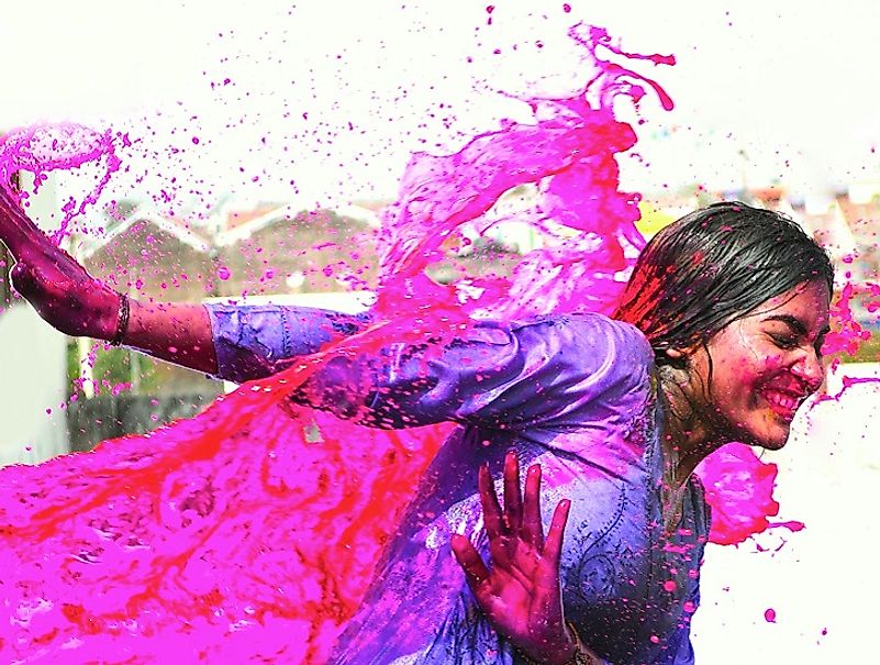 A woman splashed with colors during Holi.