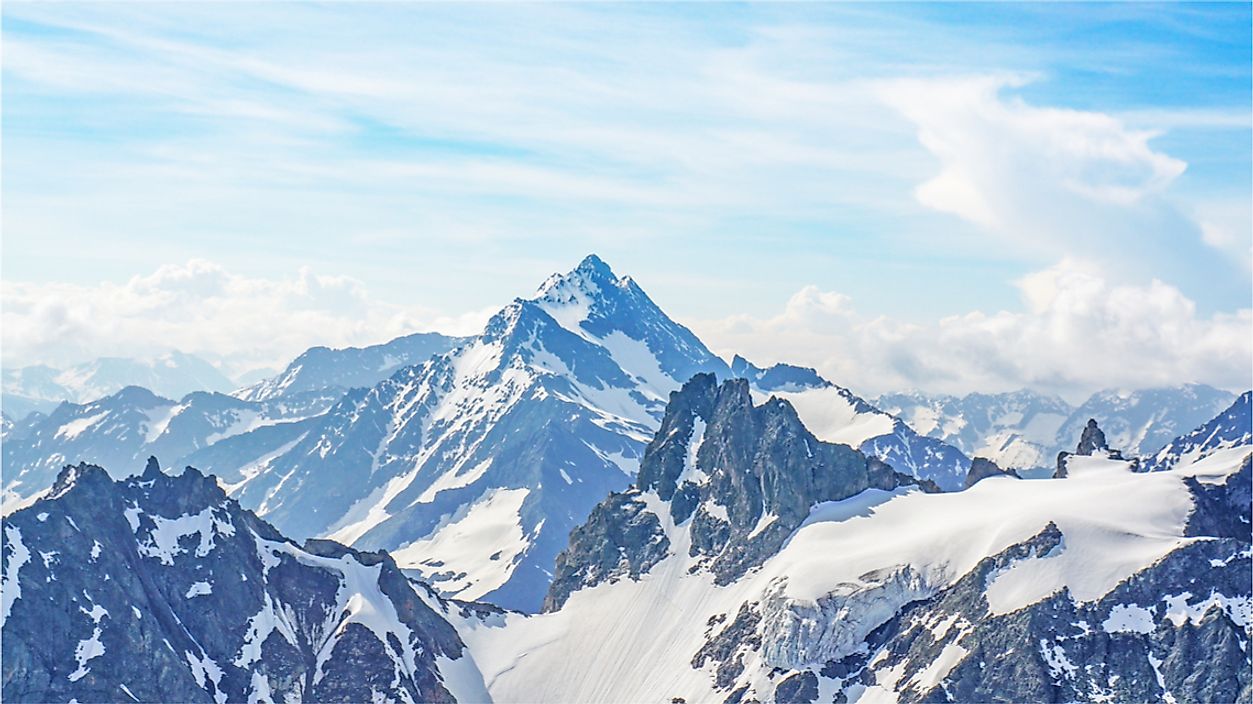Mountains, such as the Alps, are typically higher in elevation and have a more defined peaks than hills.