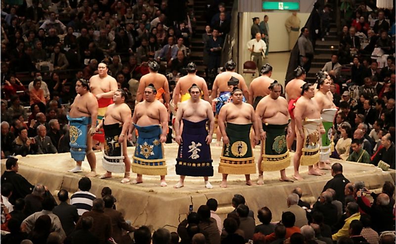 High rank sumo wrestlers line up with crowd in the Tokyo Grand Sumo Tournament. Editorial credit: J. Henning Buchholz / Shutterstock.com