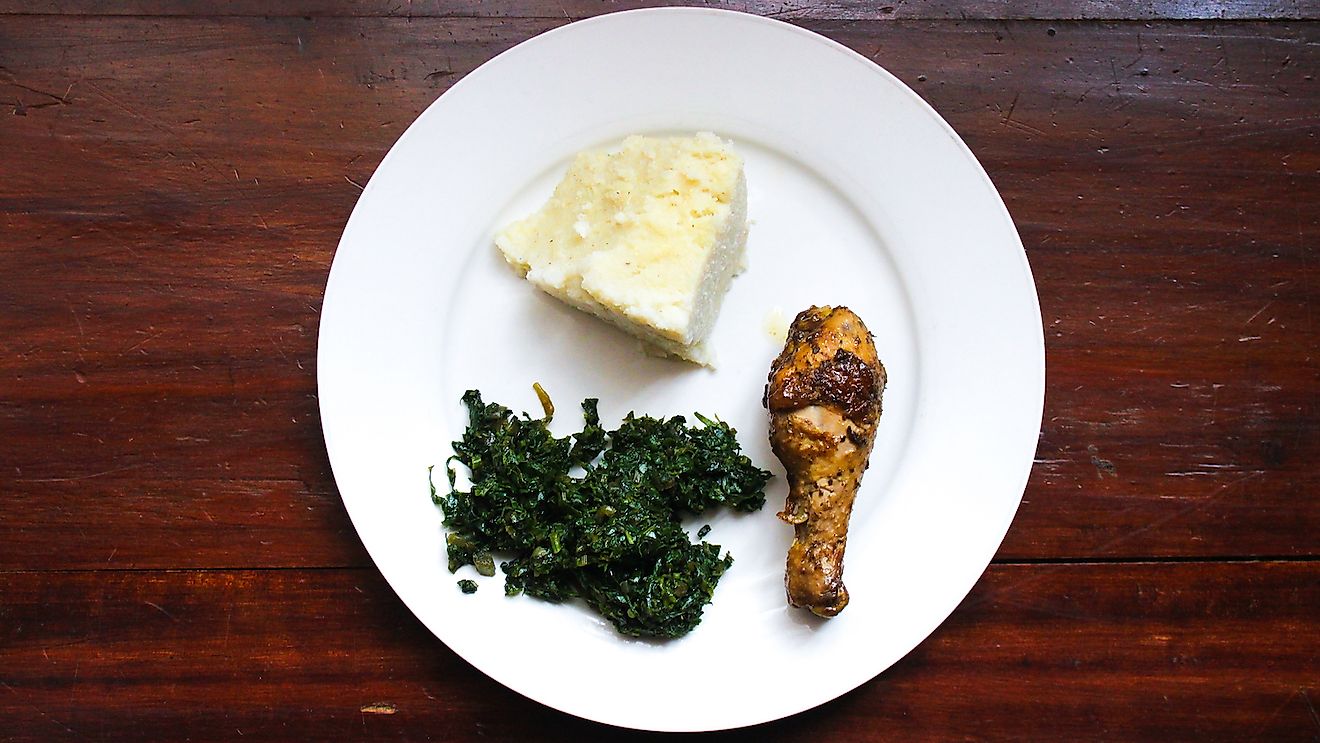 Ugali, kales and roasted chicken. Typical meal in Tanzania. Image credit: Walid Kilonzi/Shutterstock.com