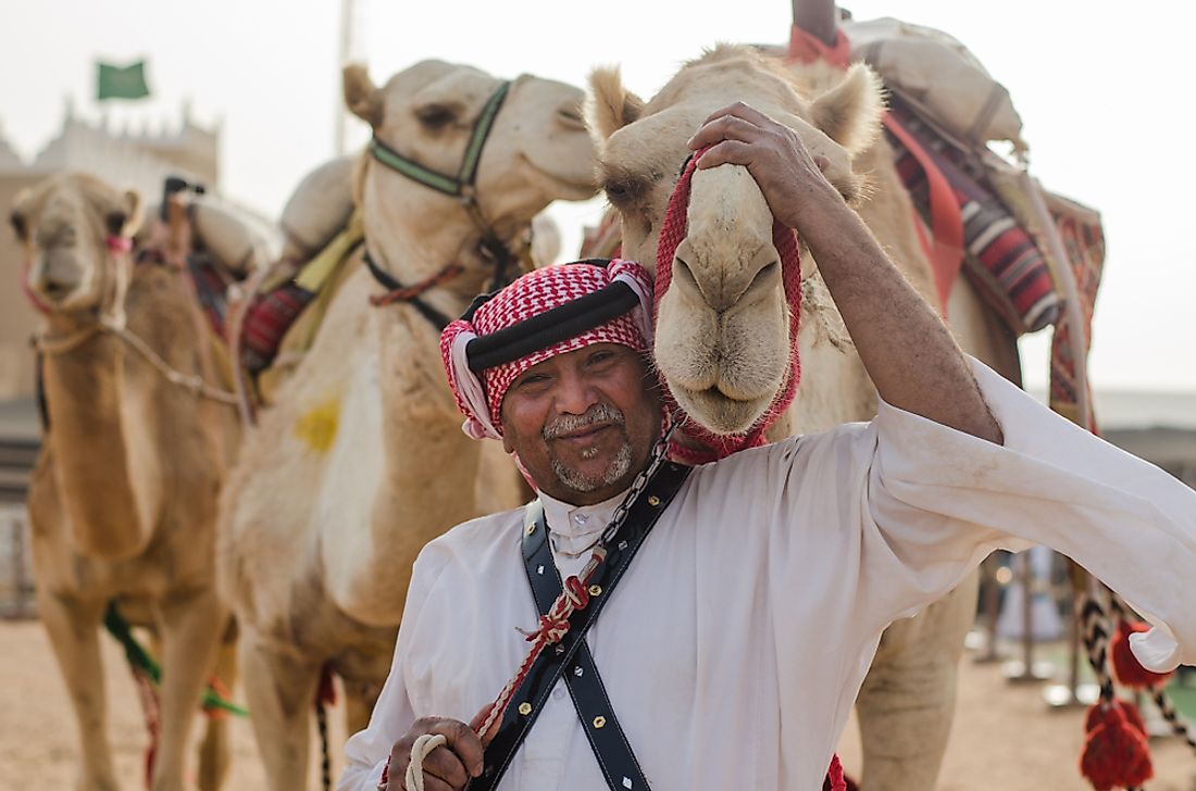 A man in Saudi Arabia with camels. Editorial credit: H1N1 / Shutterstock.com. 