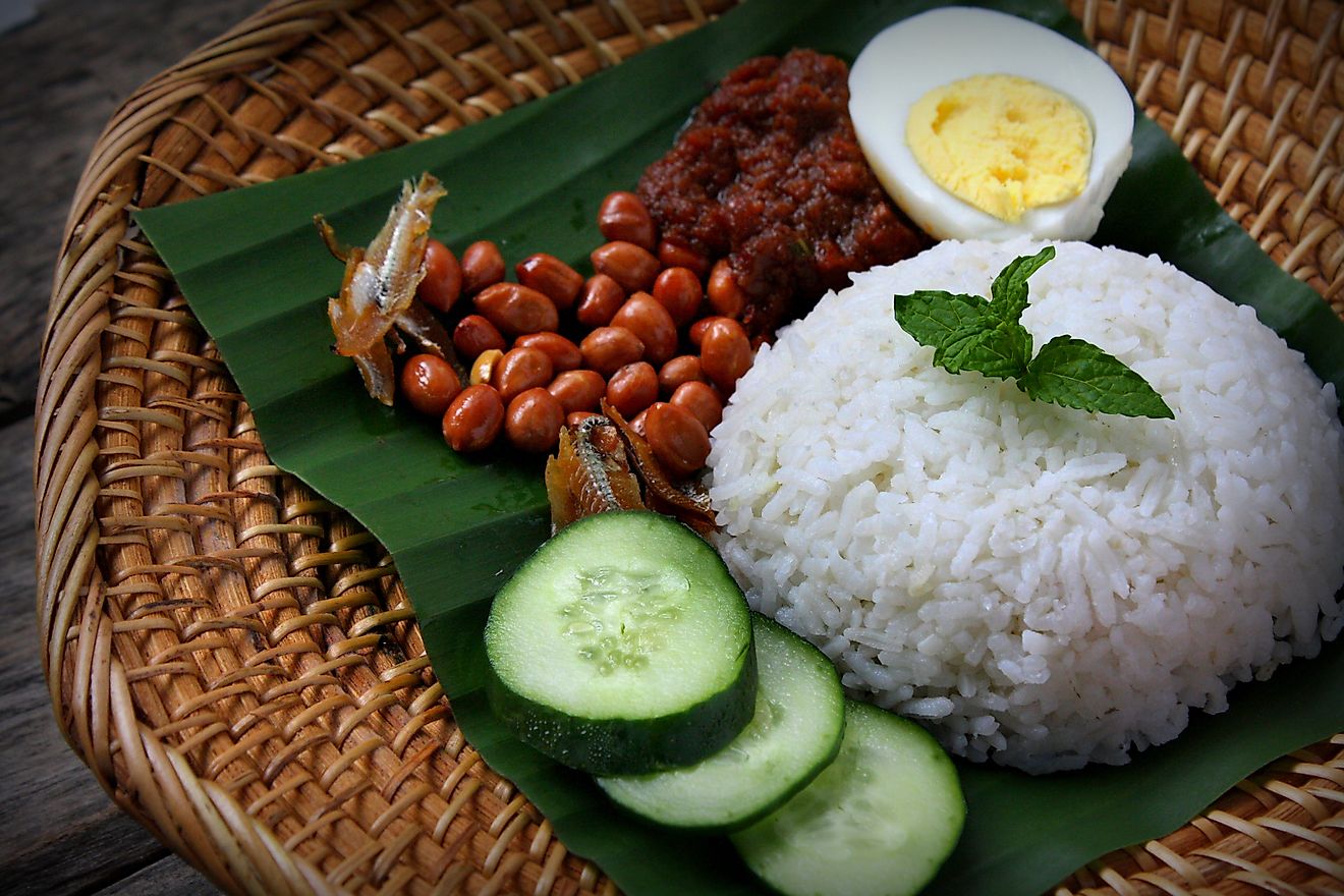 Nasi Lemak, a fragrant rice dish cooked in coconut milk and pandan leaf commonly found in Malaysia. Served with sambal, anchovies, peanut and cucumber. Image credit: Dolly MJ/Shutterstock.com