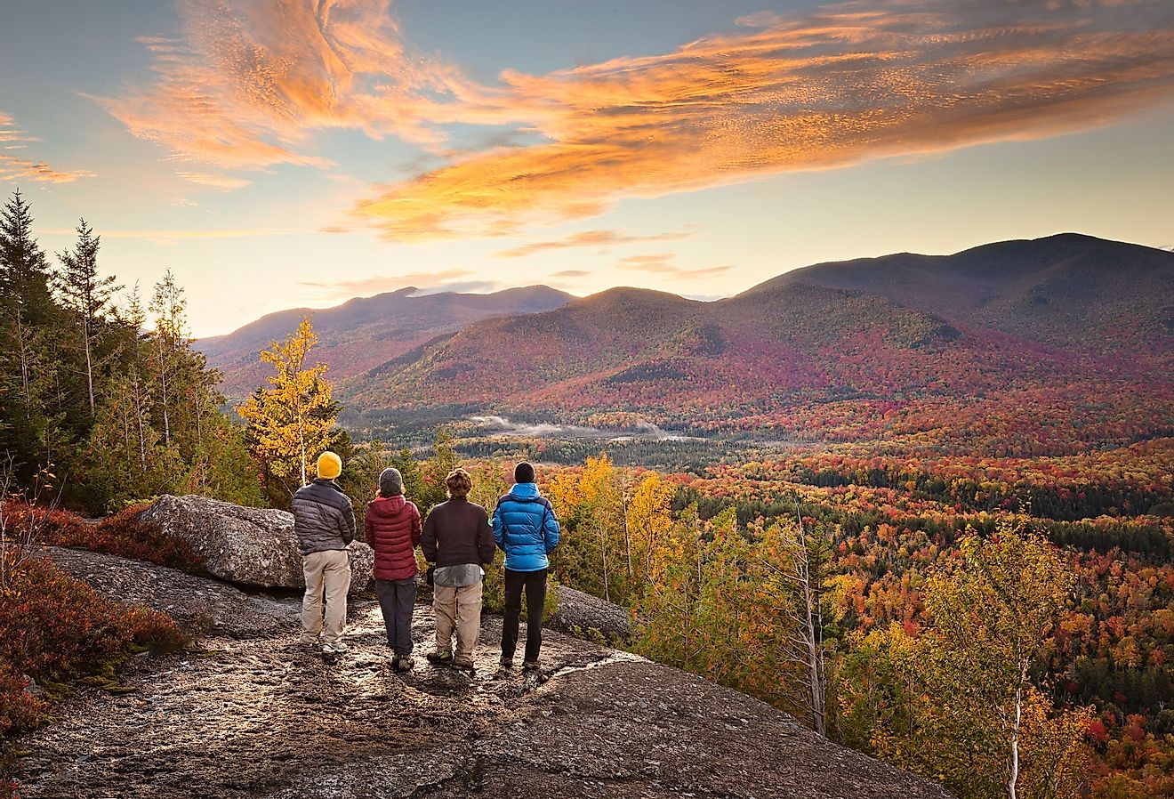 Group of hikers enjoying the view of the Adirondacks in autumn.