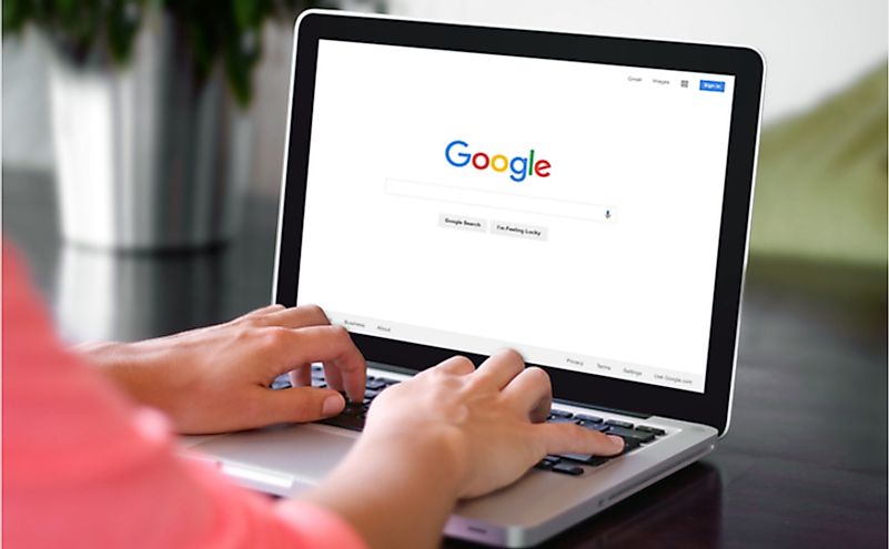 A woman is typing on Google search engine from a laptop. Editorial credit: Castleski / Shutterstock.com