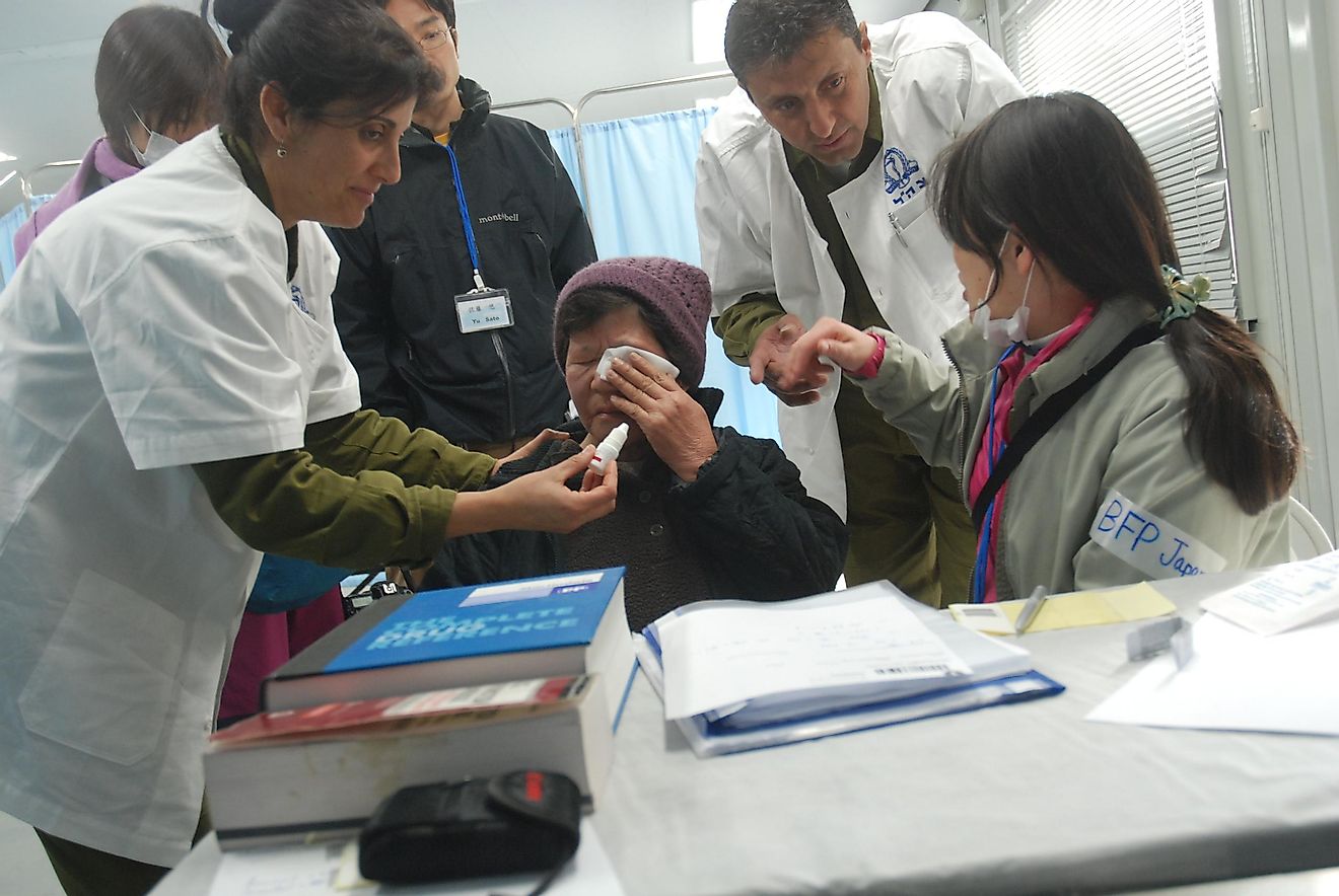 Doctors in Israel treating an aged woman.
