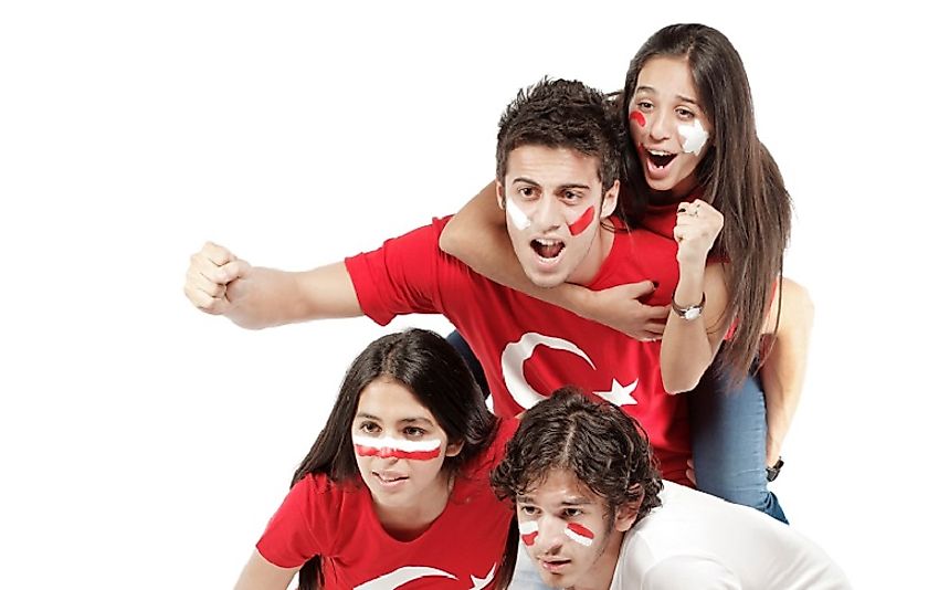 Turkish siblings watching their National Football Team on television.