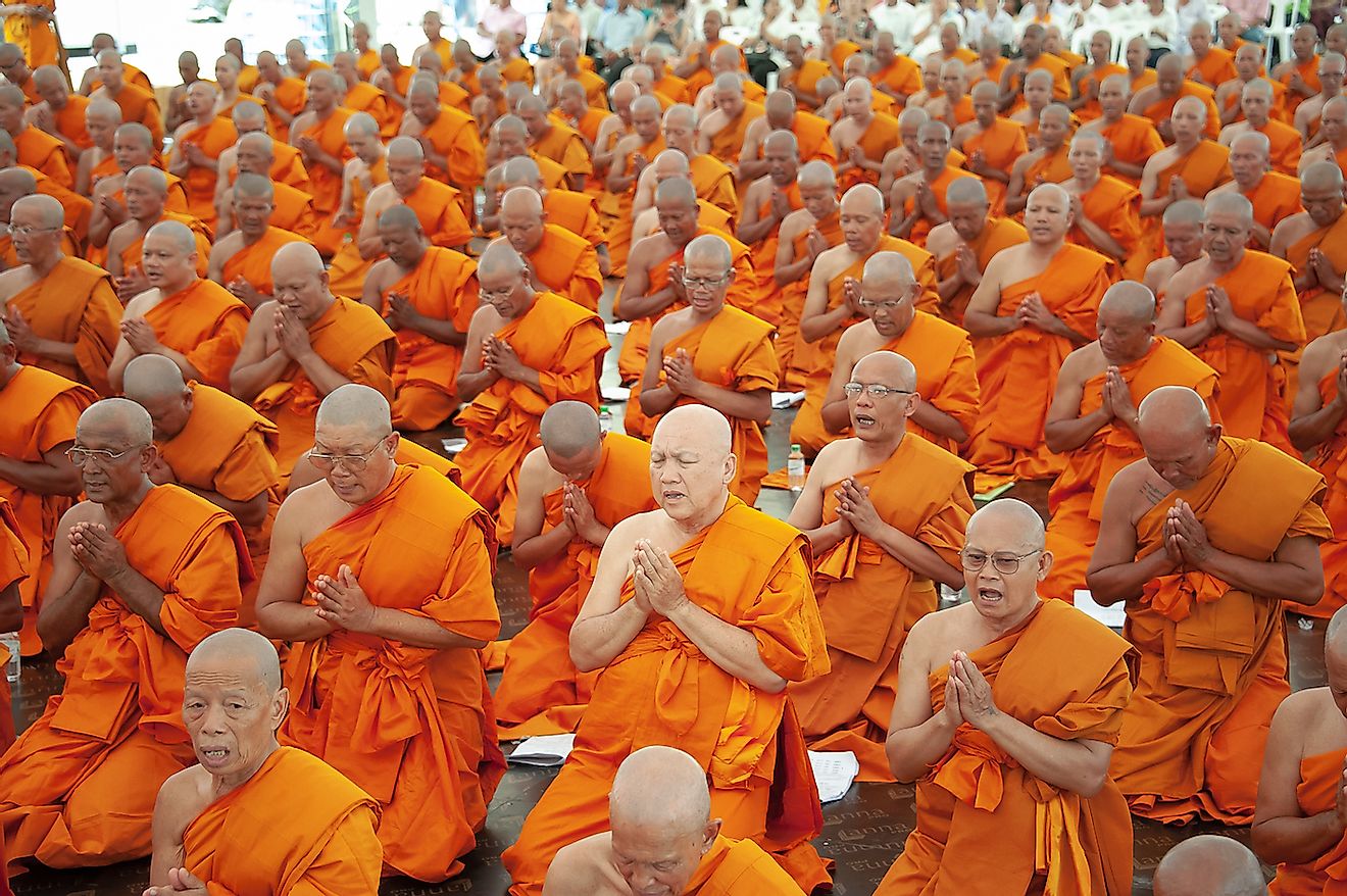 Buddhists monks pray in Bangkok, Thailand. Image credit: PhaiApirom/Shutterstock.com