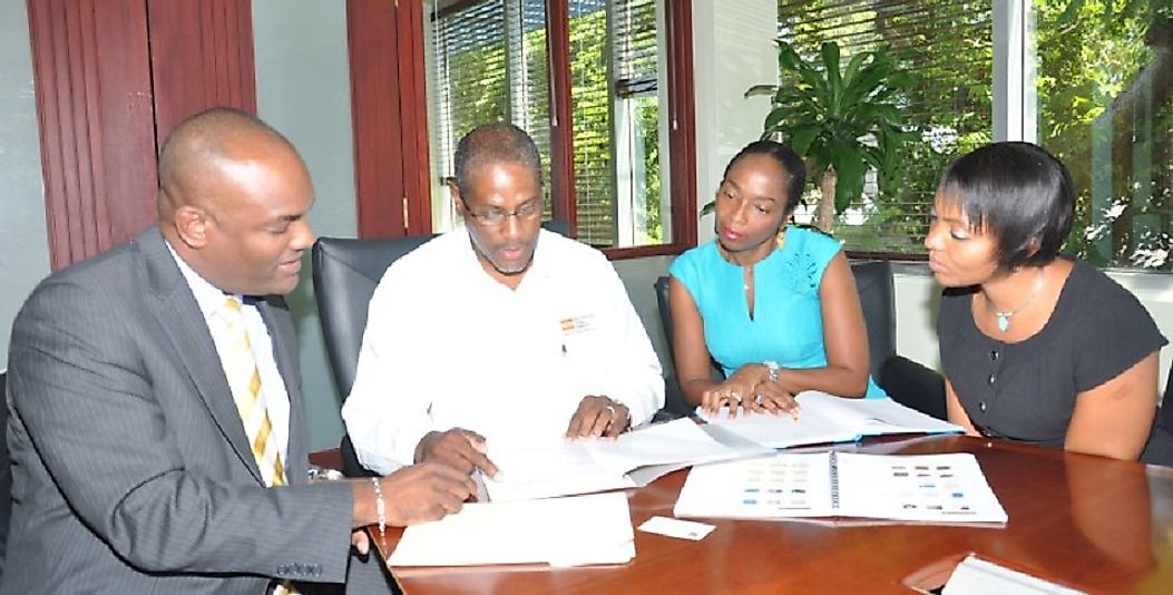 Business owners in Barbados meet with a bank's lending office to secure investment financing.