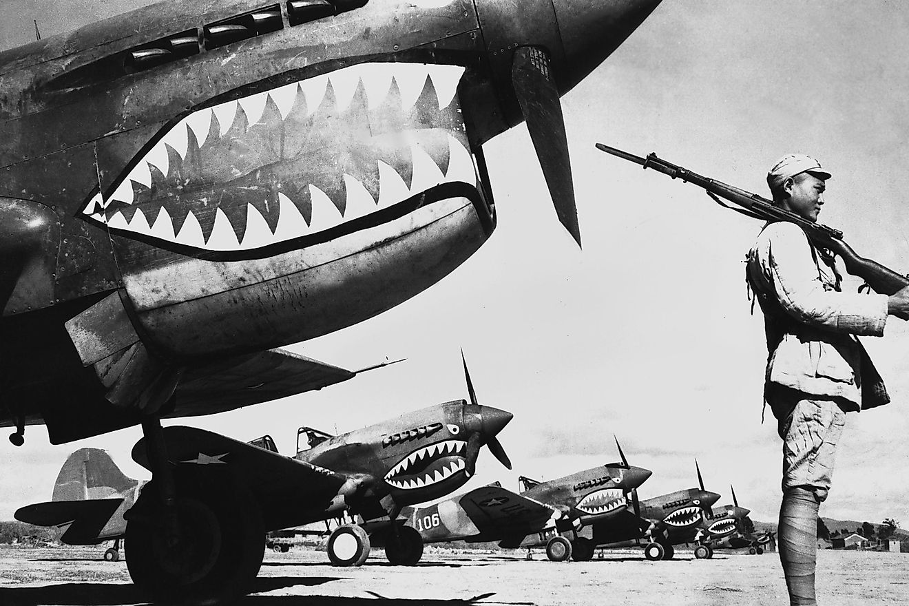 Chinese soldier guards a line of American P-40 fighter planes