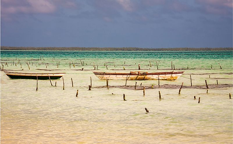 Old fishing boats in a shallow lagoon with turquoise water, Fanning Island, Kiribati Republic.