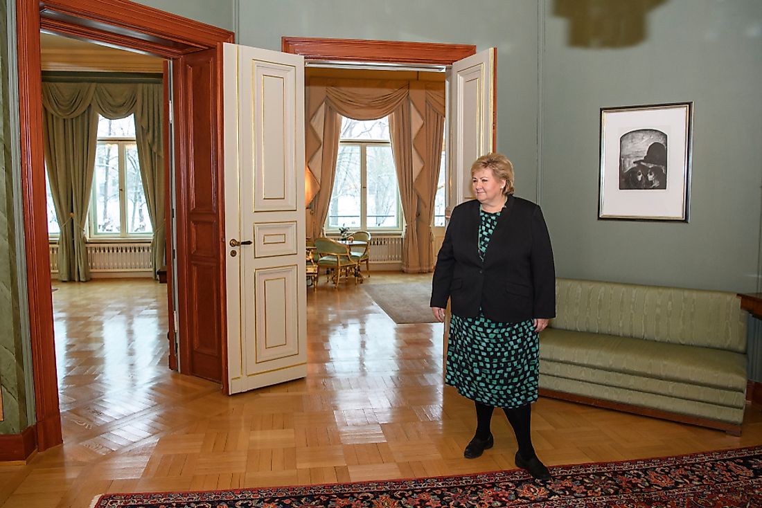 Norwegian prime minister Erna Soiberg stands in her residence in Oslo, Norway. Editorial credit: paparazzza / Shutterstock.com.