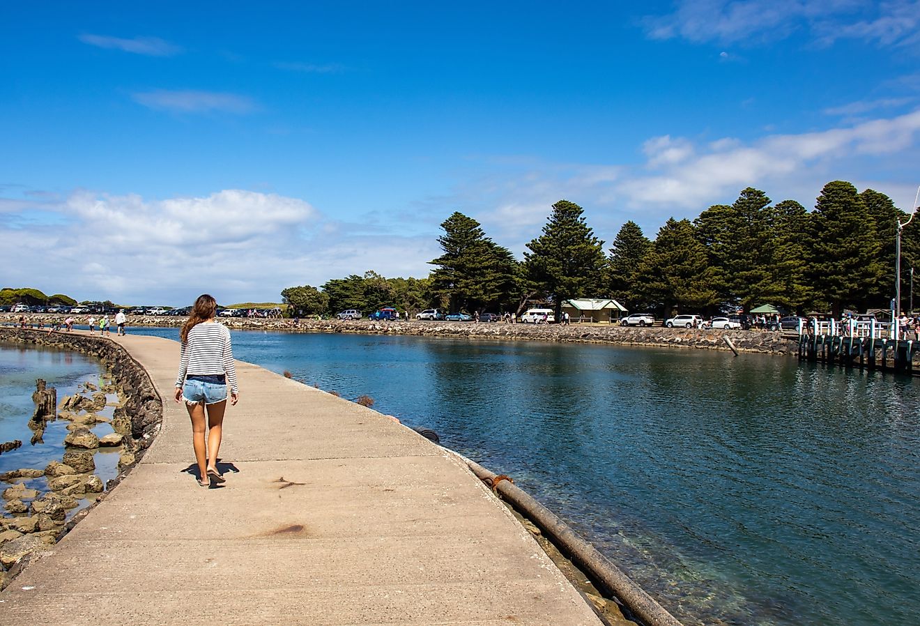 Woman walking on the on the pier in Port Fairy, Australia.