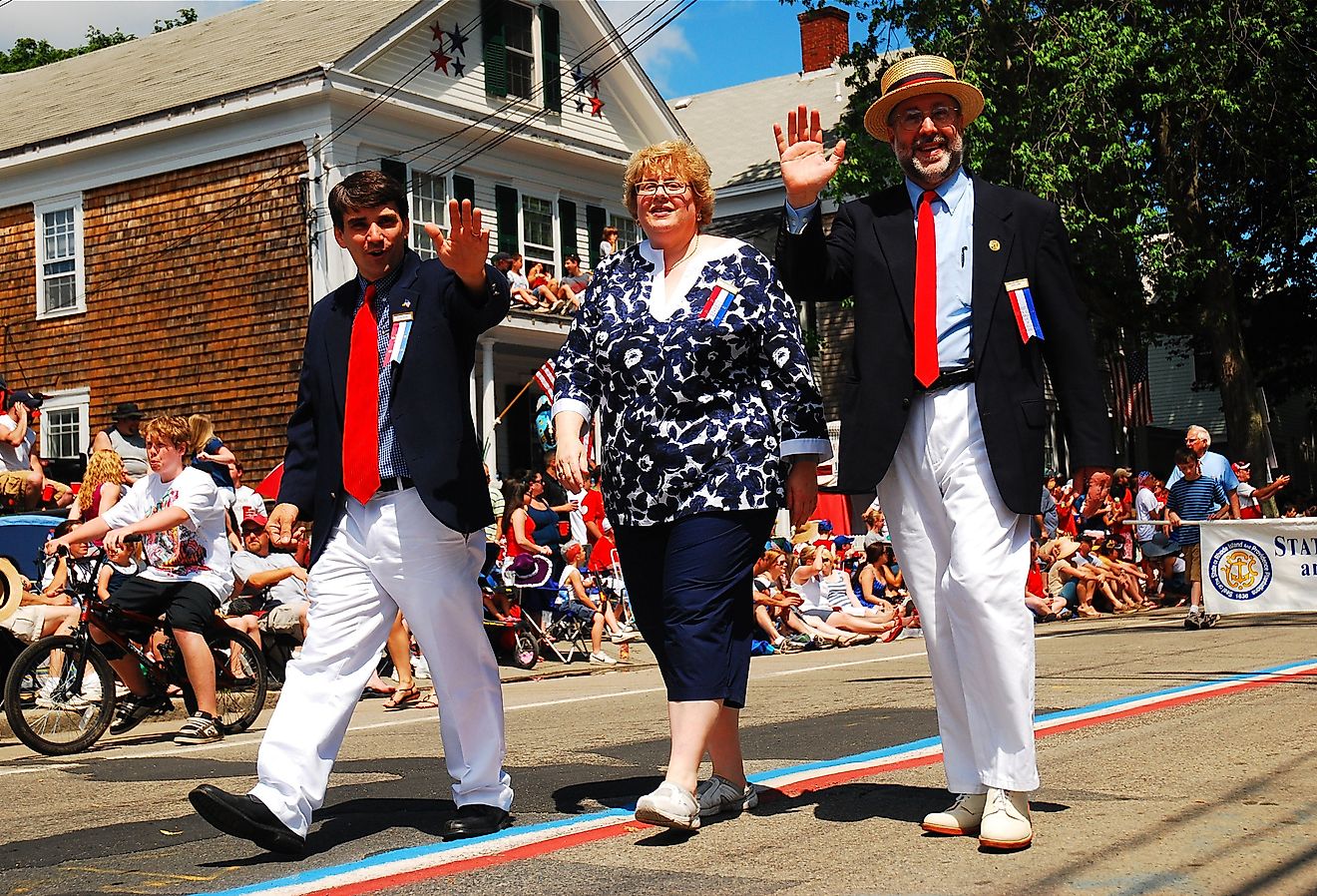 Town officials march in a Fourth of July parade in Bristol, Rhode Island. Image credit James Kirkikis via Shutterstock