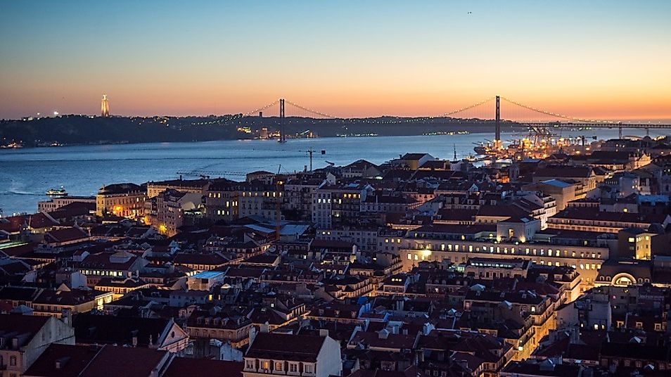 The Tagus River flowing through Lisbon, Portugal at night, shortly before emptying into the Atlantic Ocean.