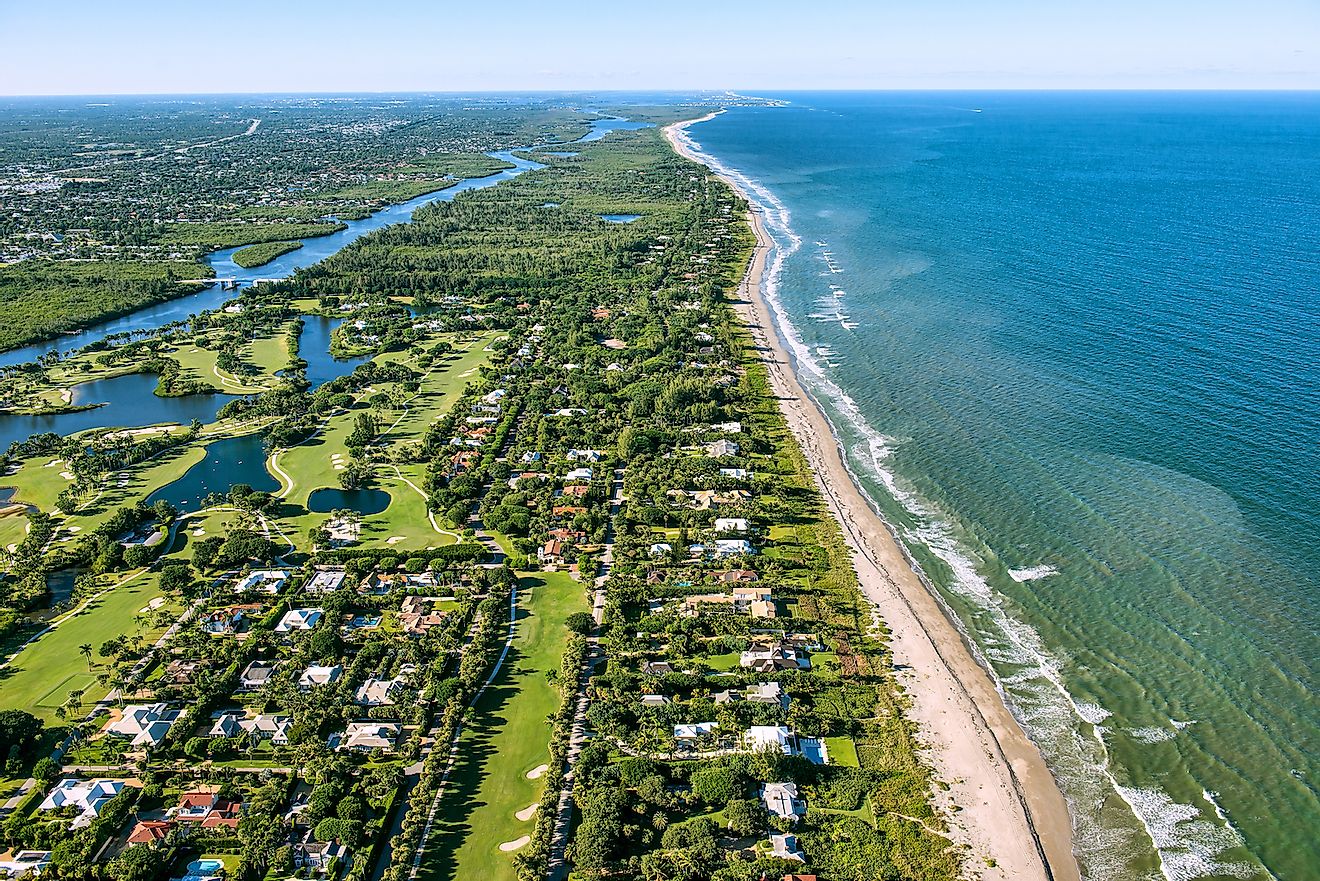 Jupiter and Hobe Sound, Florida, along the Atlantic Ocean coast, lined by the beach and dotted by luxury homes golf courses. Image credit: FloridaStock/Shutterstock.com