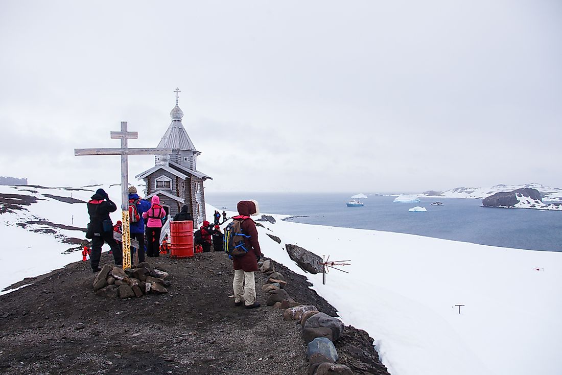 Patrons stand outside of Trinity Church, near the Russian Bellingshausen Station in Antarctica. 