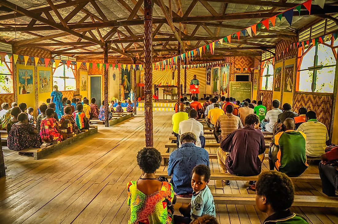 Community members attending mass at a church in Papua New Guinea. Editorial credit: Michal Knitl / Shutterstock.com