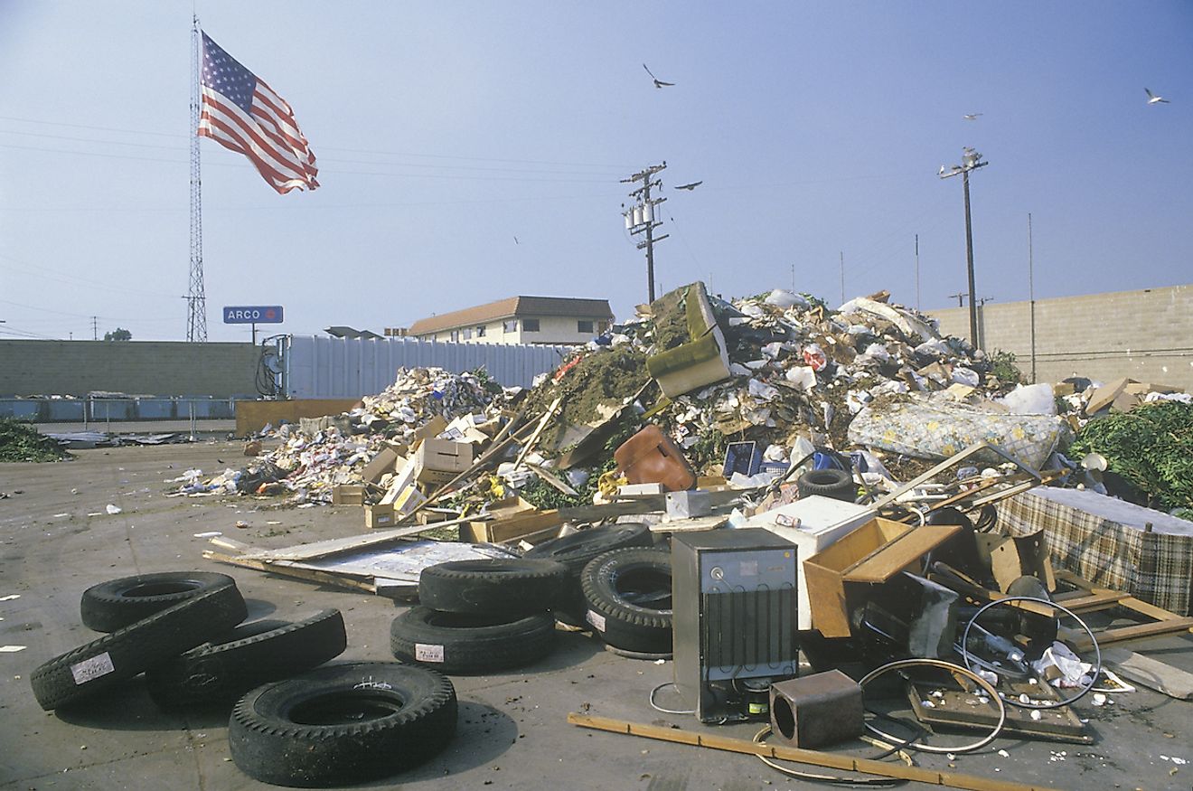 An American flag waving in the distance behind a dump site at the Santa Monica Community Center, CA. Image credit: Joseph Sohm/Shutterstock.com