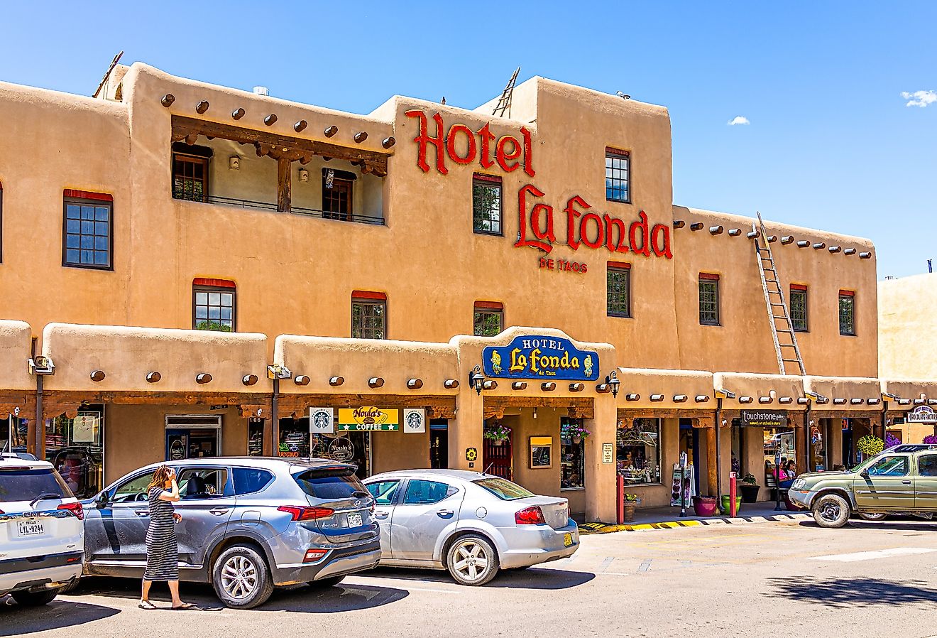 Downtown McCarthy's plaza square in famous town city village old town with sign exterior for Hotel La Fonda, Taos, New Mexico. Image credit Andriy Blokhin via Shutterstock