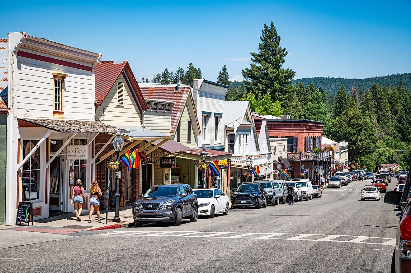 Shops and eateries along Broad Street in Nevada City, California, featuring rainbow flags during Pride Month. Editorial credit: Chris Allan / Shutterstock.com