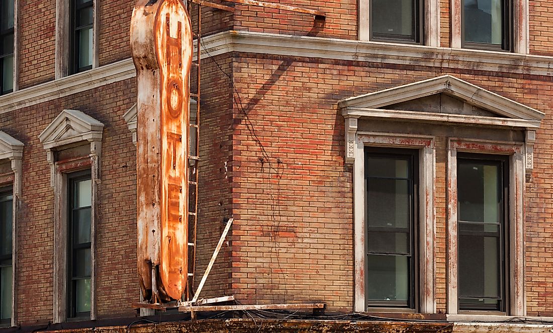 Editorial credit: Antonio Gravante / Shutterstock.com. The sign of a historic hotel in New York shows signs of a fire from earlier days.
