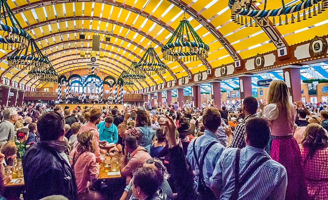 Tourists explore the tents of Oktoberfest in Munich. Editorial credit: Takashi Images / Shutterstock.com.