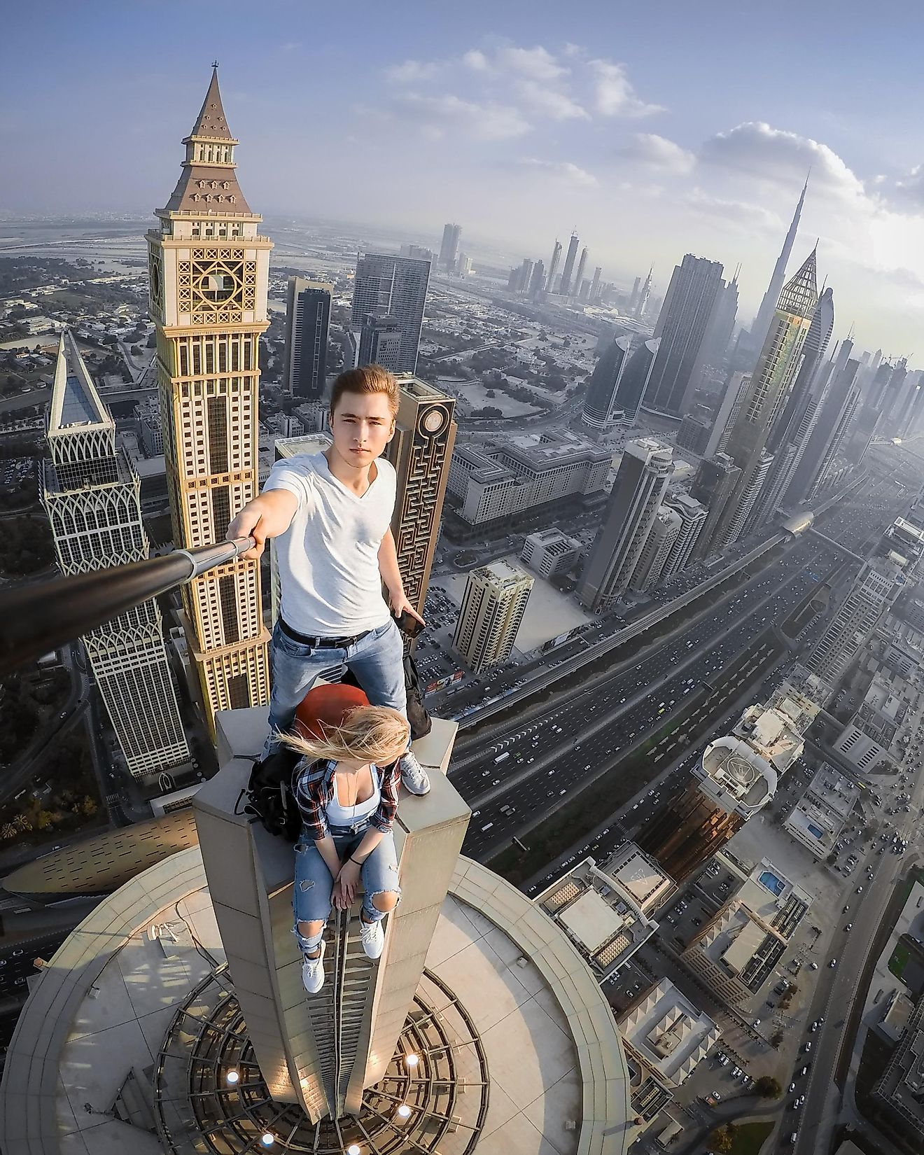 Young couple takes a selfie on a skyscraper in Dubai, United Arab Emirates