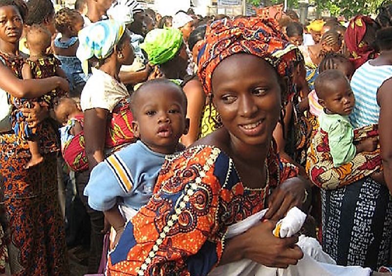This Sierra Leone woman and her child join crowds celebrating government expansion of maternal healthcare in 2010.