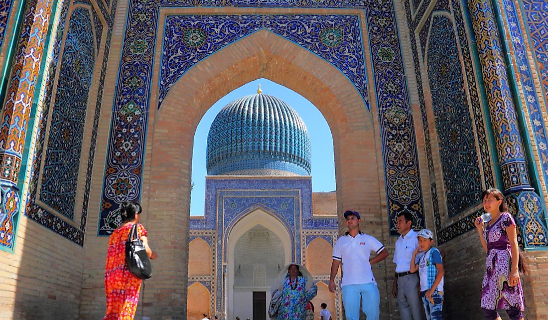 Travelers tour the Bibi-Khanym Mosque in Uzbekistan. Photo credit: Natalia Davidovich / Shutterstock.com. 