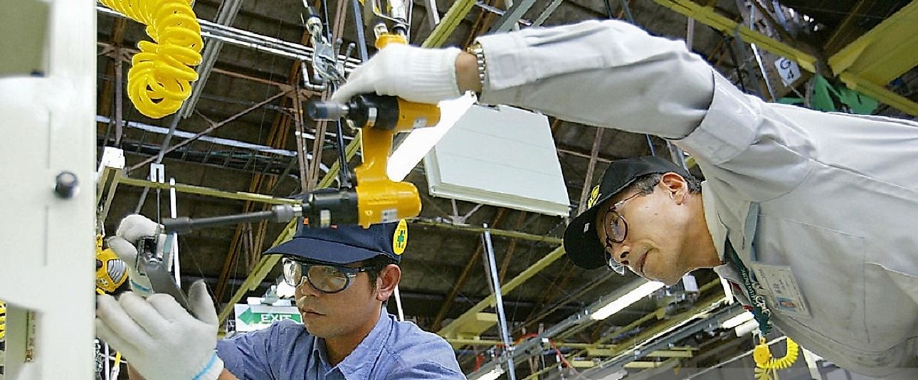An employee receives on the job training in this Japanese automotive factory.