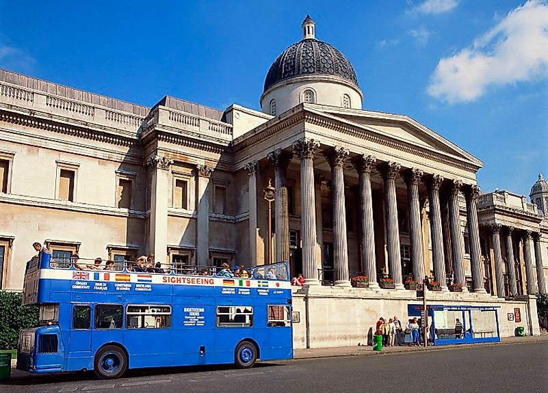 A bus drops of eager tourists at the British National Gallery in London, England, United Kingdom.