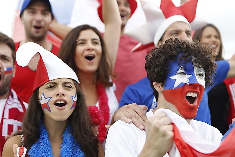 A group of young Chilean adults cheer on their national soccer team.