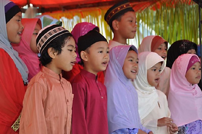 Cocos children dressed in traditional Malay attire and singing.