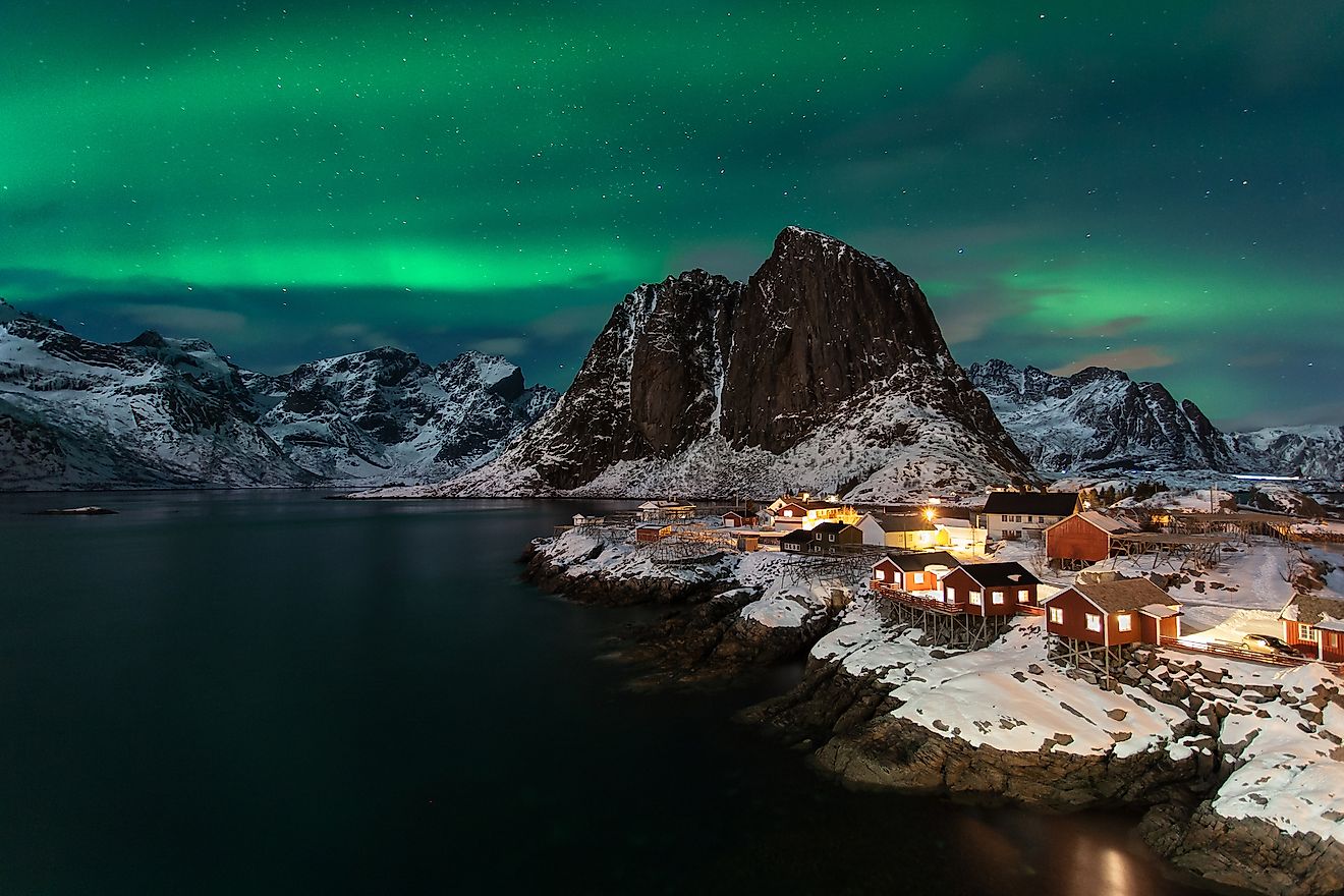 Classic fisherman village in Lofoten island Norway with a beautiful Northern Lights. Image credit: Luca Tagliani/Shutterstock.com