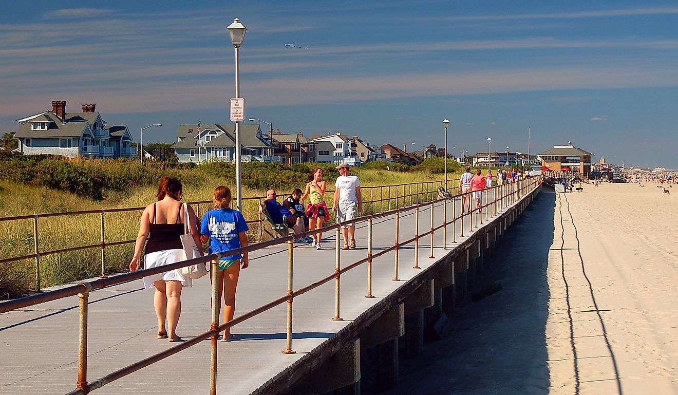 Folks enjoy a summer's day leisurely strolling on the boardwalk in Spring Lake, New Jersey. Editorial credit: James Kirkikis / Shutterstock.com
