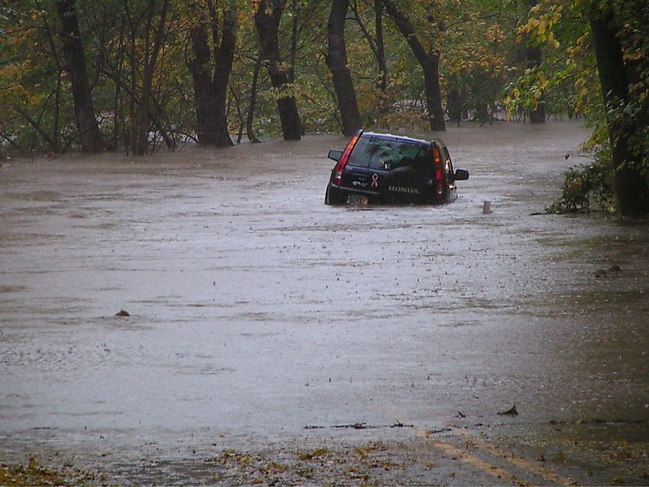 A car partially submerged from the quick rising waters of a flash flood.