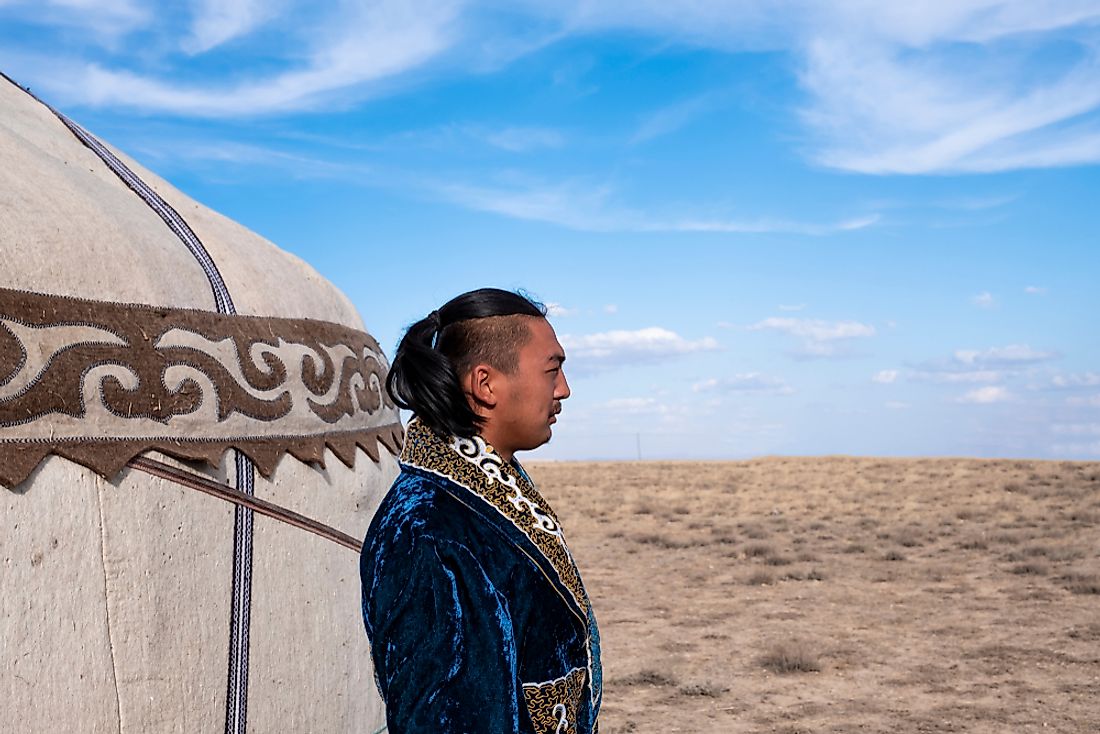A Kyrgyz man dressed in a traditional outfit. Editorial credit: Ahmet Cigsar / Shutterstock.com.