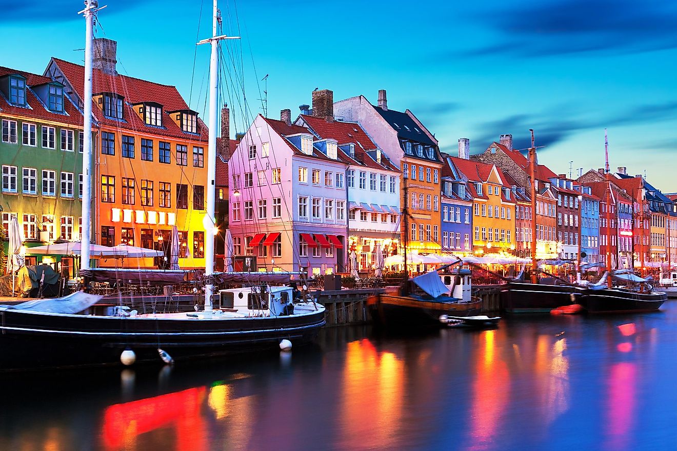 Scenic evening panorama of famous Nyhavn pier architecture in the Old Town of Copenhagen, Denmark.