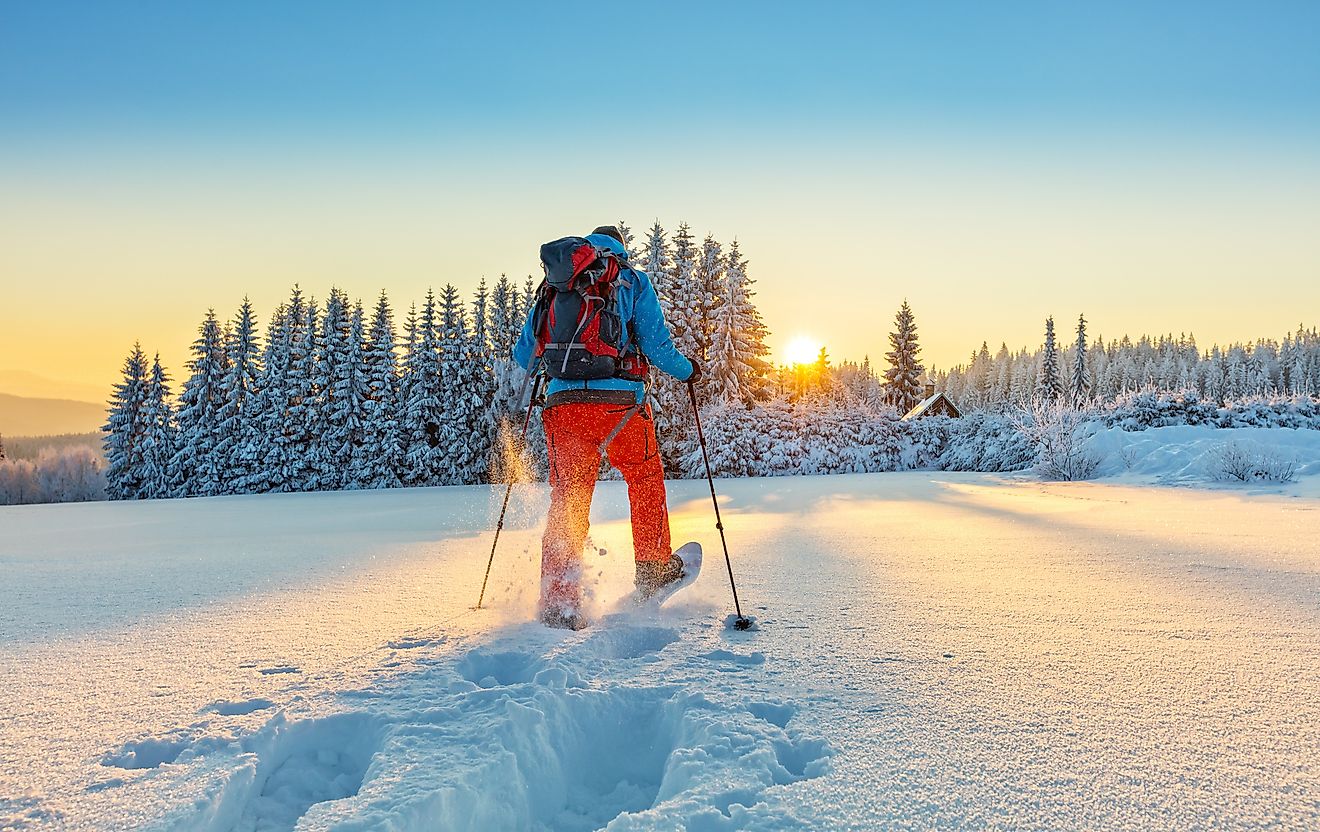 Snowshoe walker running in powder snow with beautiful sunrise light. Image credit: Jag_cz/Shutterstock.com